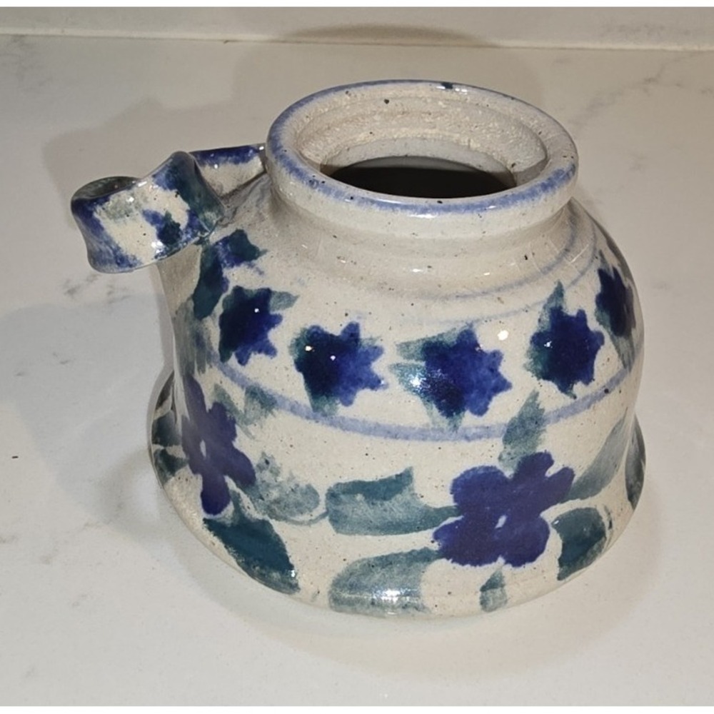Handmade stoneware pottery pitcher approximately 2.5 inches tall.